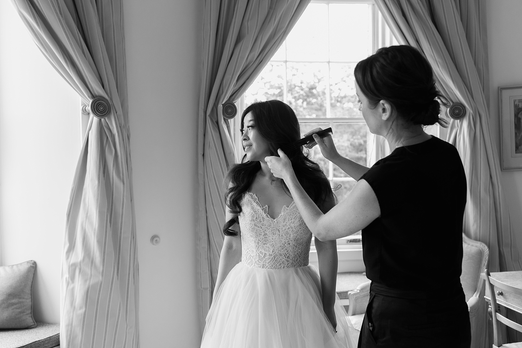 american bride getting into hayley paige wedding dress at cluny castle wedding scotland with jodie gibb makeup artists