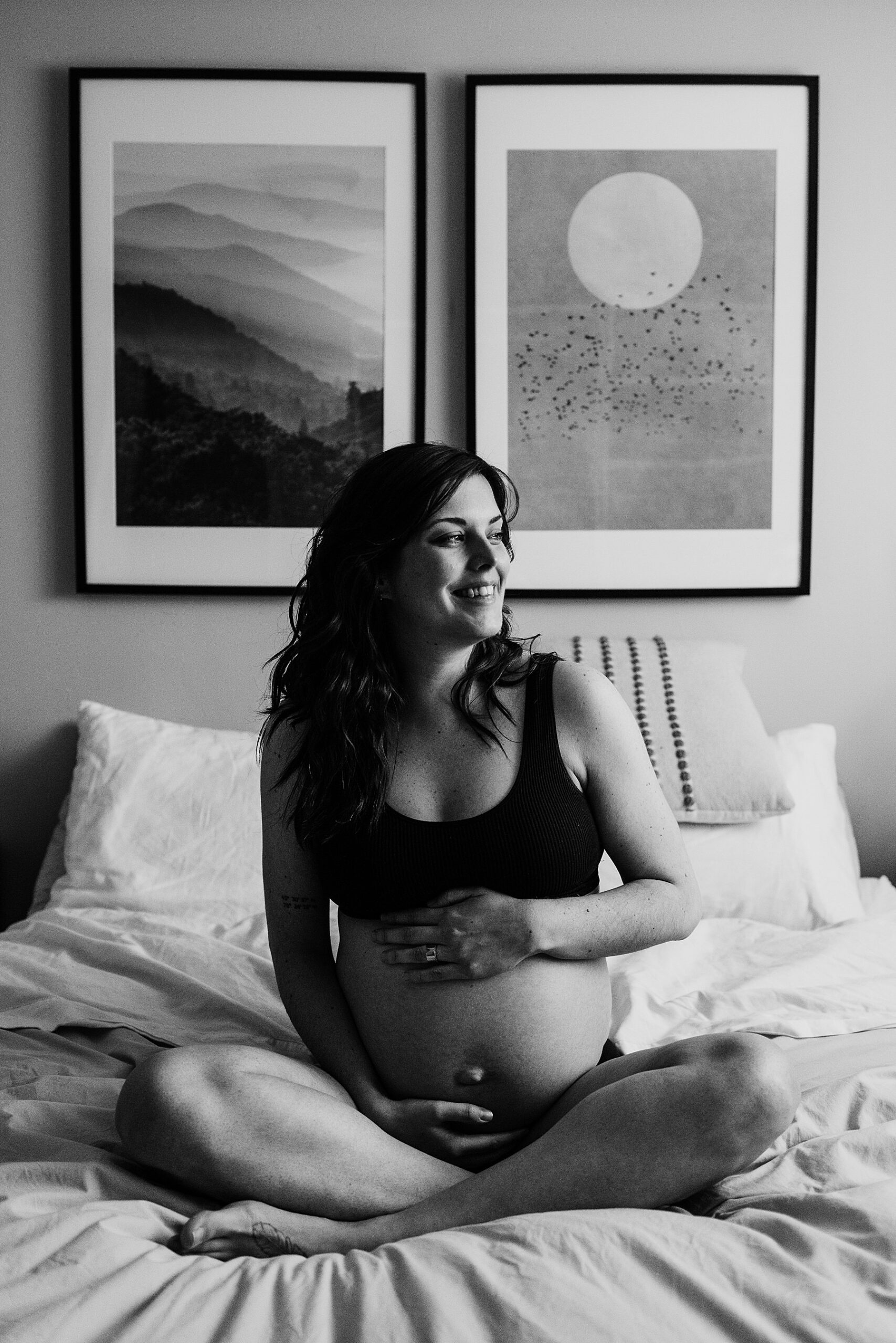 maternity photography toronto bump photoshoot showing heavily pregnant woman sitting cross legged on a bed in mississauga GTA ontario